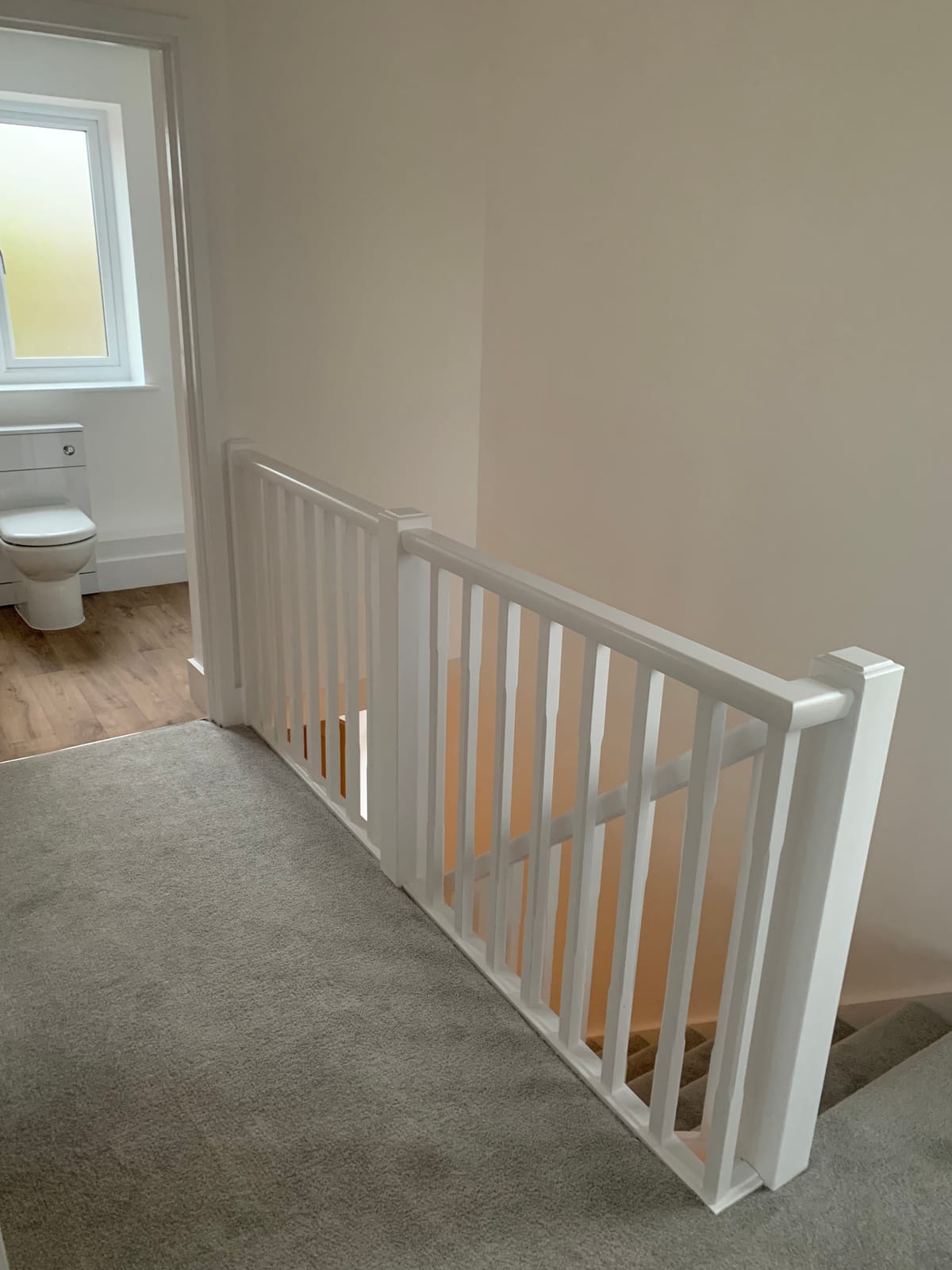 A new staircase balustrade with white spindles on a landing
