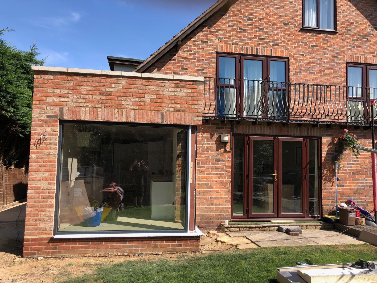 A finished brick extension with a large corner window onto the garden