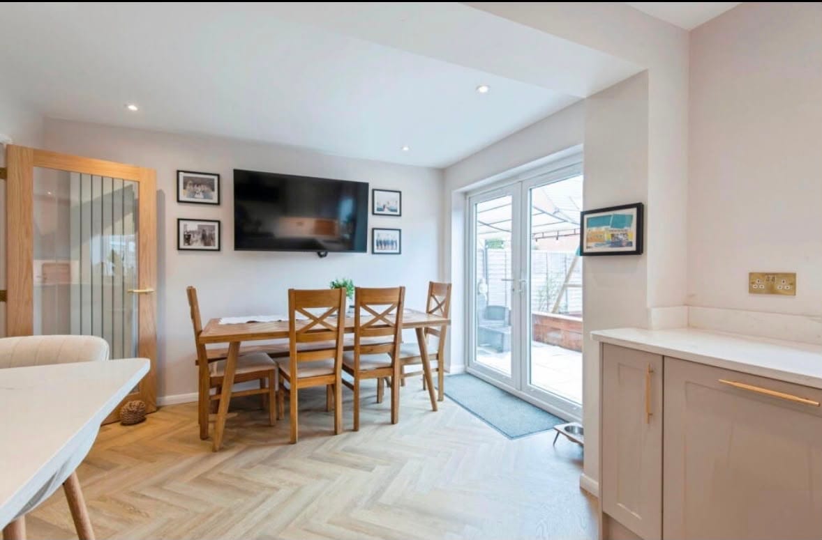 A finished dining area with French doors onto the garden