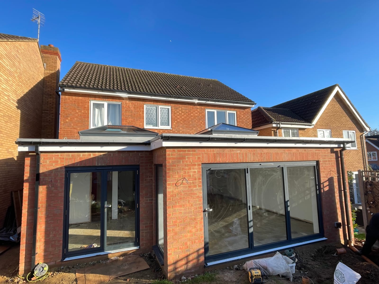 Brick rear extension with roof lanterns and sliding doors